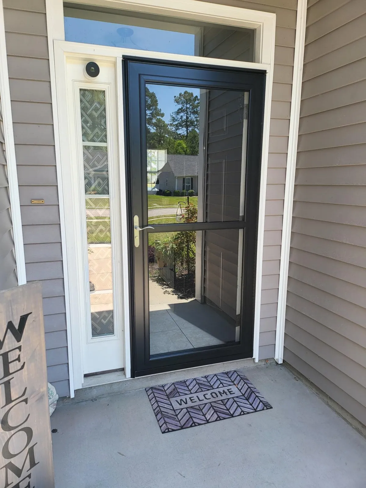 a beautiful glass door with black frame