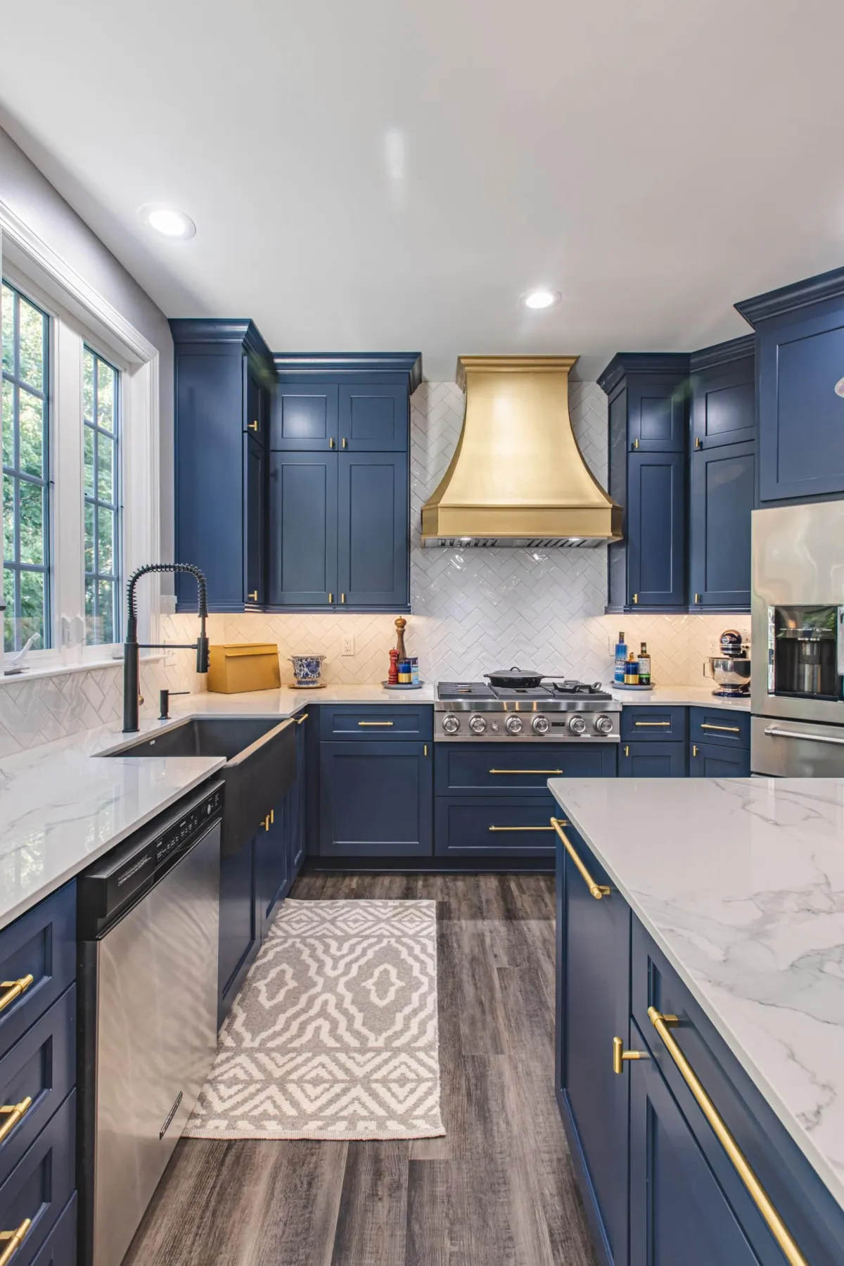 a newly remodeled kitchen with blue cabinets