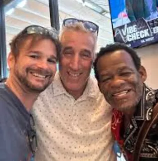 Isolated portrait of a model holding Field Dew serum bottle