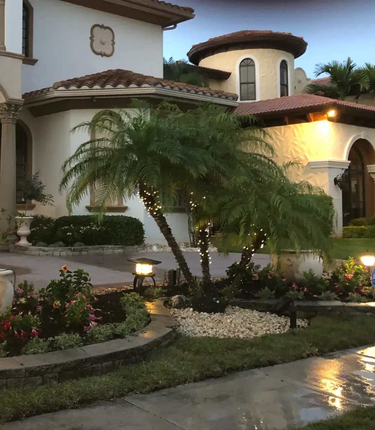 Luxury home landscaping at night in Deerfield Beach – Quality Lawncare & Landscaping