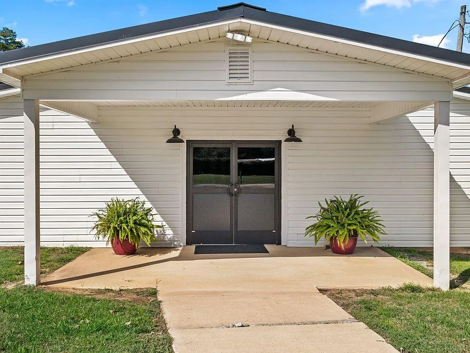 A group of people standing around a metal fence