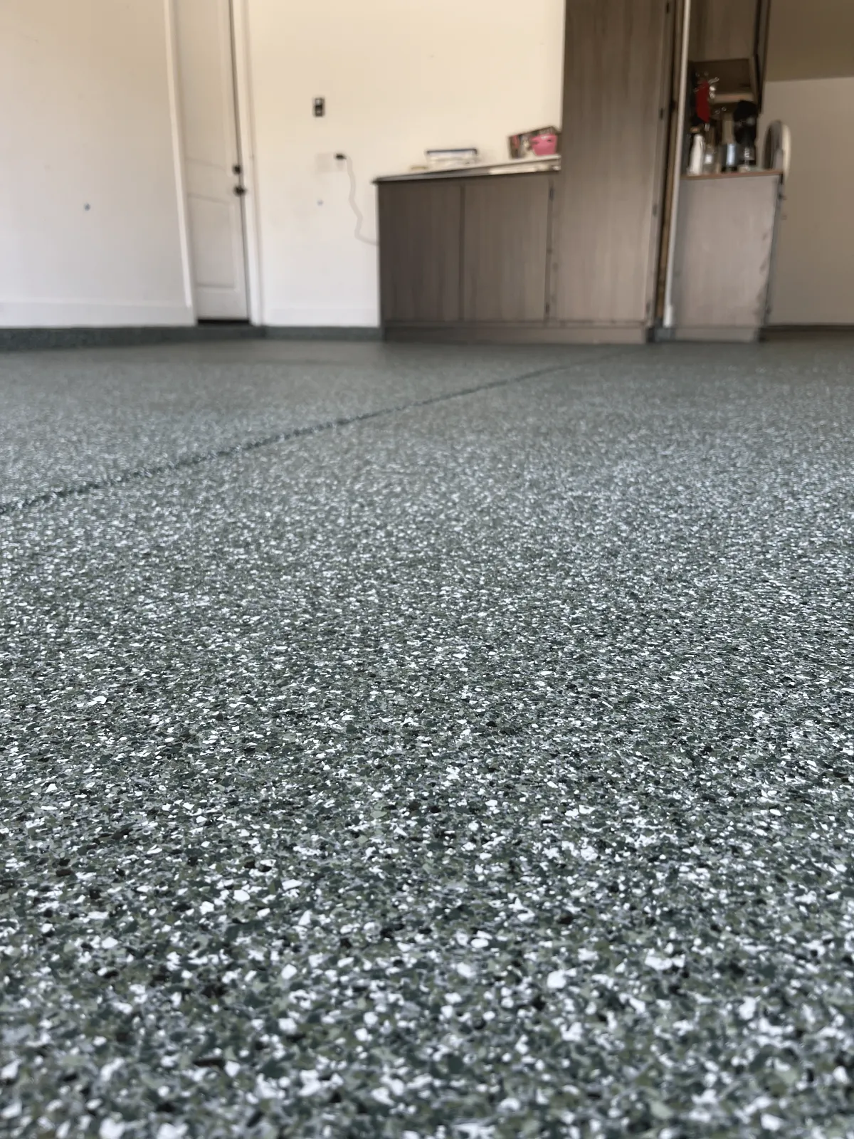 Shiny warehouse floor with overhead lights and ceiling