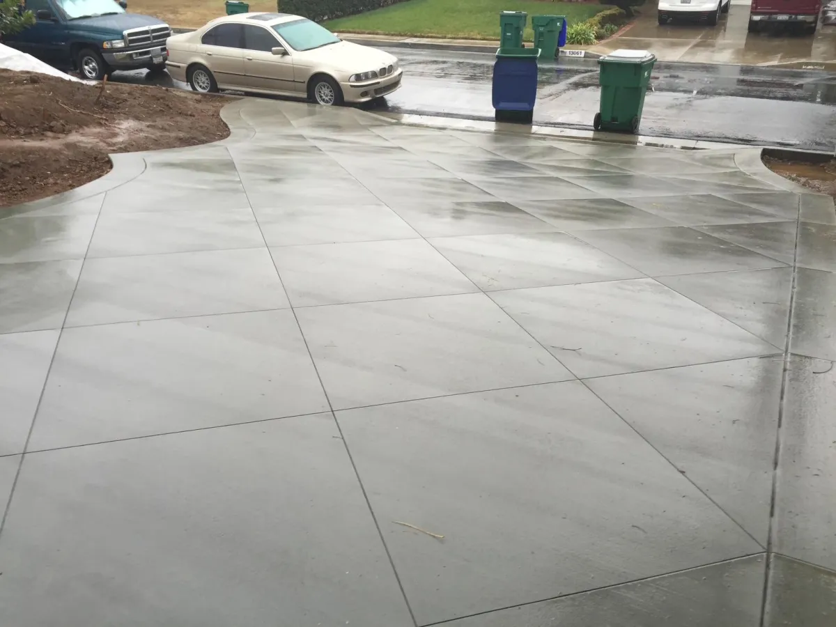 Fresh concrete driveway with diamond cuts and border outline cut.