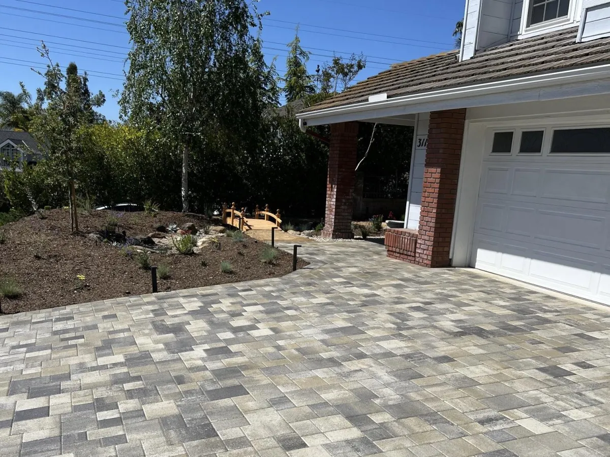 Interlocking paver installation for a front driveway and front door approach of a home.