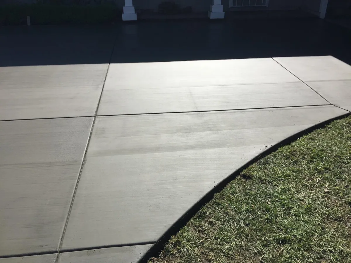 Standard concrete driveway with square cuts.