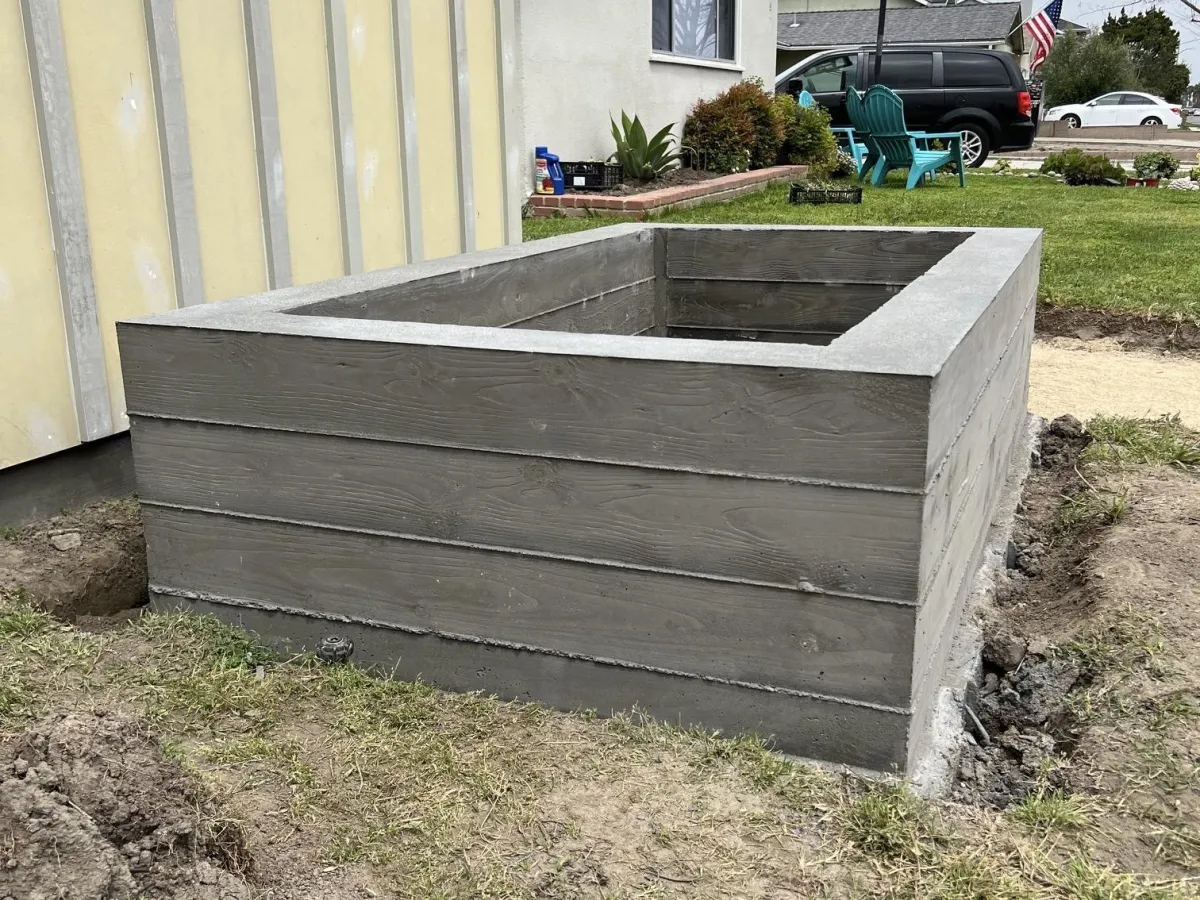 Custom raised concrete planter. (Four short concrete walls creating a box.