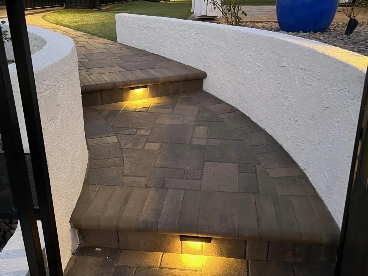 Interlocking paver walkway featuring lighted steps.