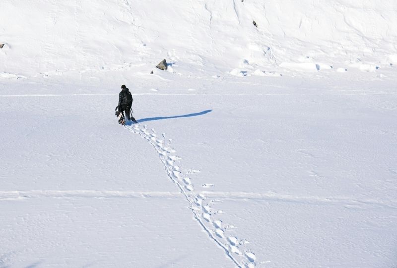 A man trekking across the Arctic.