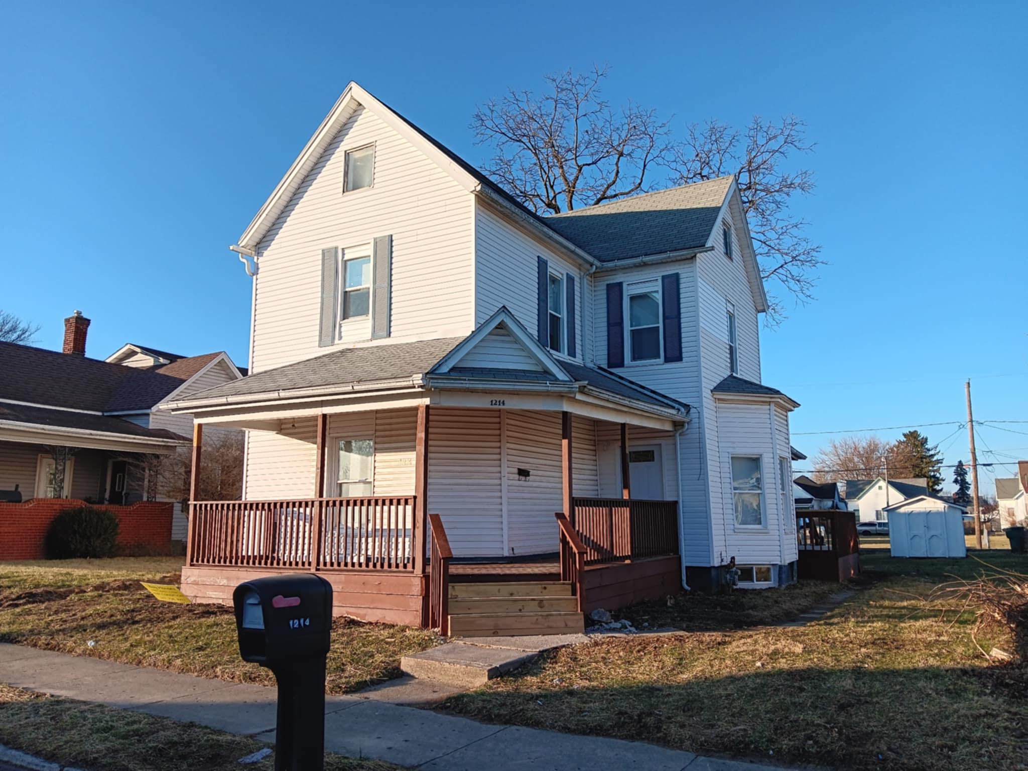 a living room with white furniture and wood floors