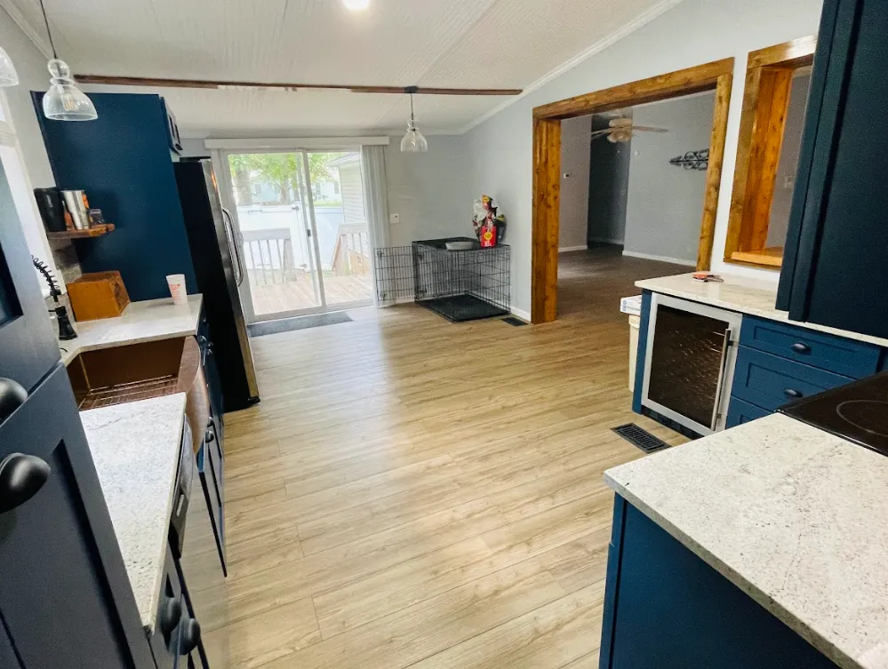 a kitchen with blue cabinets and hardwood floors