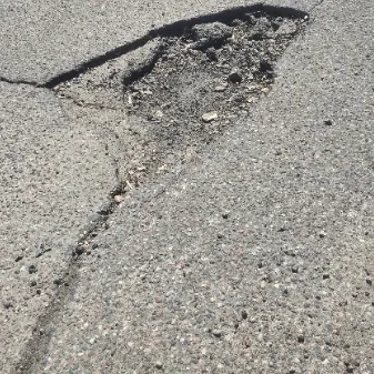 Asphalt pothole and localized pavement failure showing deteriorated pavement in Wisconsin