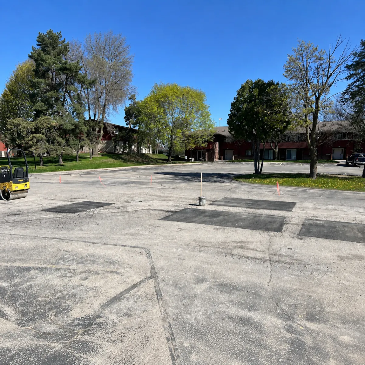 Multiple asphalt patch repairs across a deteriorated parking lot in Wisconsin