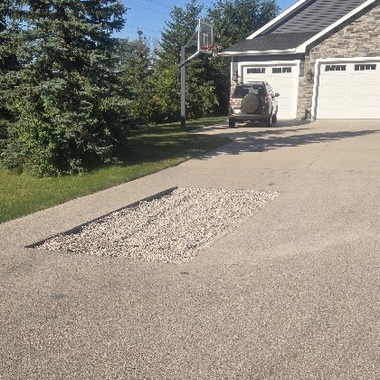 Crew saw cutting asphalt pavement to prepare a damaged area for repair in Wisconsin