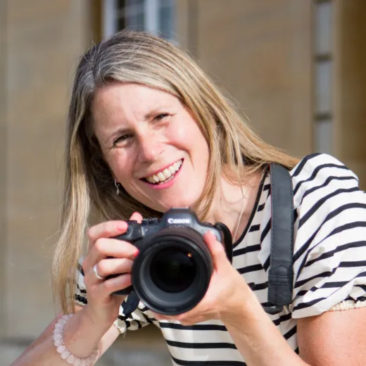Becky Kerr, commercial photographer specialising in brand photography for design businesses, with camera on location in Bedfordshire