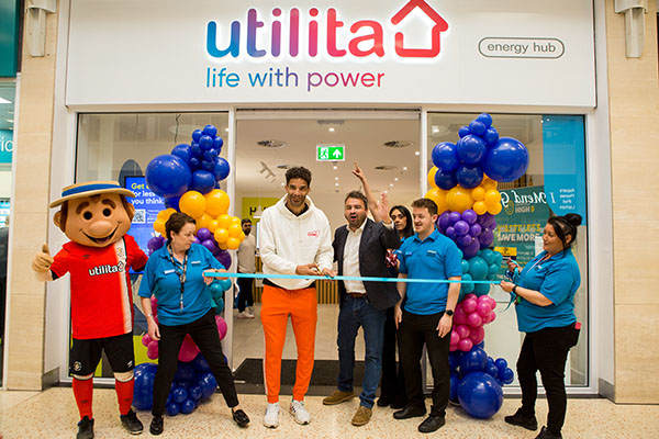 Event photography of former England goalkeeper David James cutting ribbon at Utilita energy showroom launch ceremony
