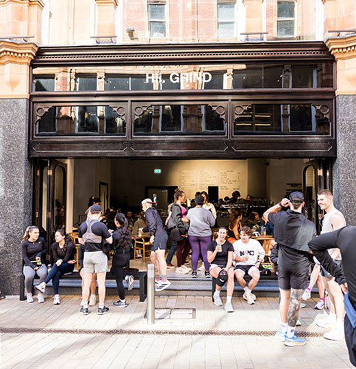 Commercial event photography of Nike running club at Hii Grind, Leeds with runners standing outside. 