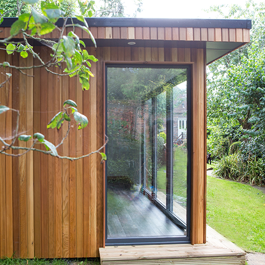 photography for an architect of a wooden and glass Sumer house in a garden setting