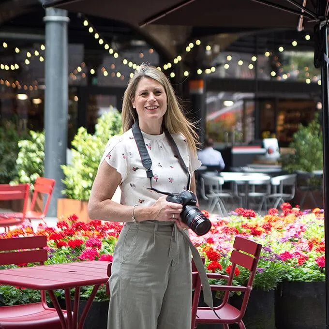 A photo of Becky Kerr photography in a London street with flowers and red chair 
