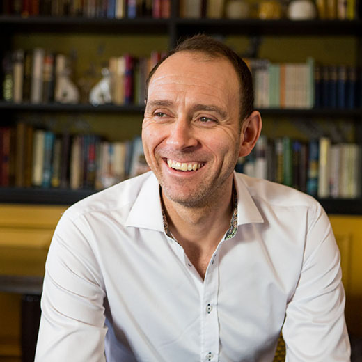 Male portrait headshot taken in a library of a Bedford hotel.