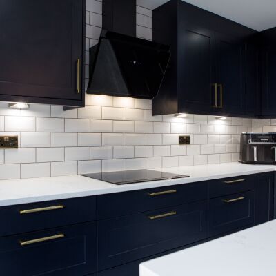 dark blue cupboard and white worktops of a kitchen for brand photography