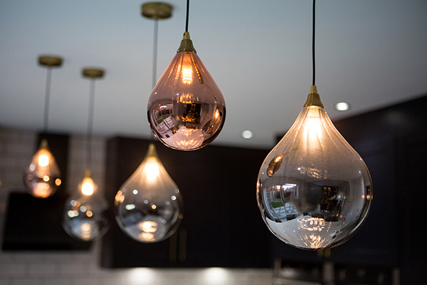 Commercial interior photography of striking silver and bronze pendant lights from Hot house interior of Ampthill reflecting kitchen design created by TC Kitchens brand
