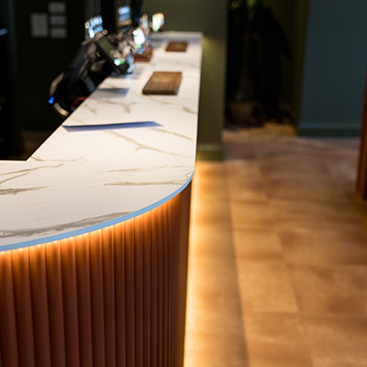 Interior design photography of a light bar with beer pumps and green walls