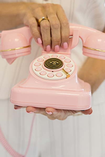 brand photography in Bedfordshire pink telephone being head by a female 