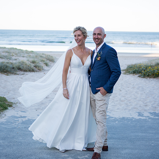 bride and groom photograph on a sandy beach 