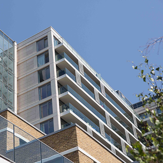 architecture photography of a flats n London blue Skys and glass balconies