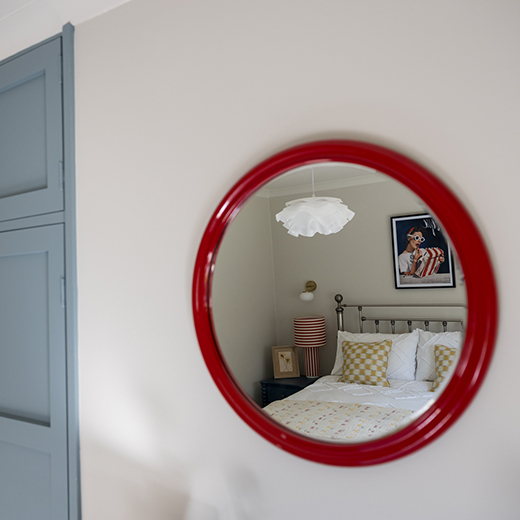 Interior photography reflection in a red mirror of a bedroom