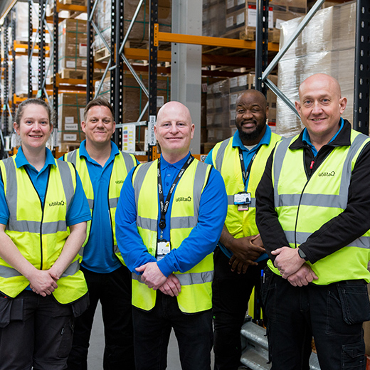 Group headshots pin a factory photography wearing hi viz jackets and lanyards