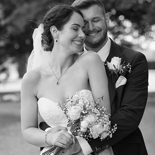 bride and groom laughing and hugging each other