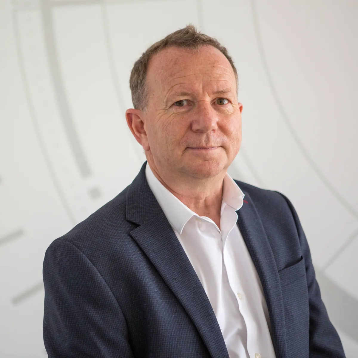 Bedfordshire headshot photography man in a suite in his office