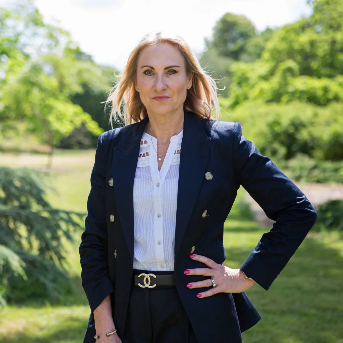CEO Headshots portrait photography wearing a Chanel belt and blue suit .