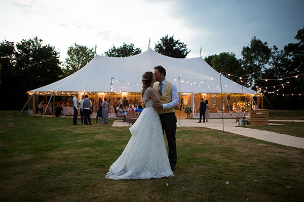 bride and groom at a marquee at golden hour in  Bedfordshire