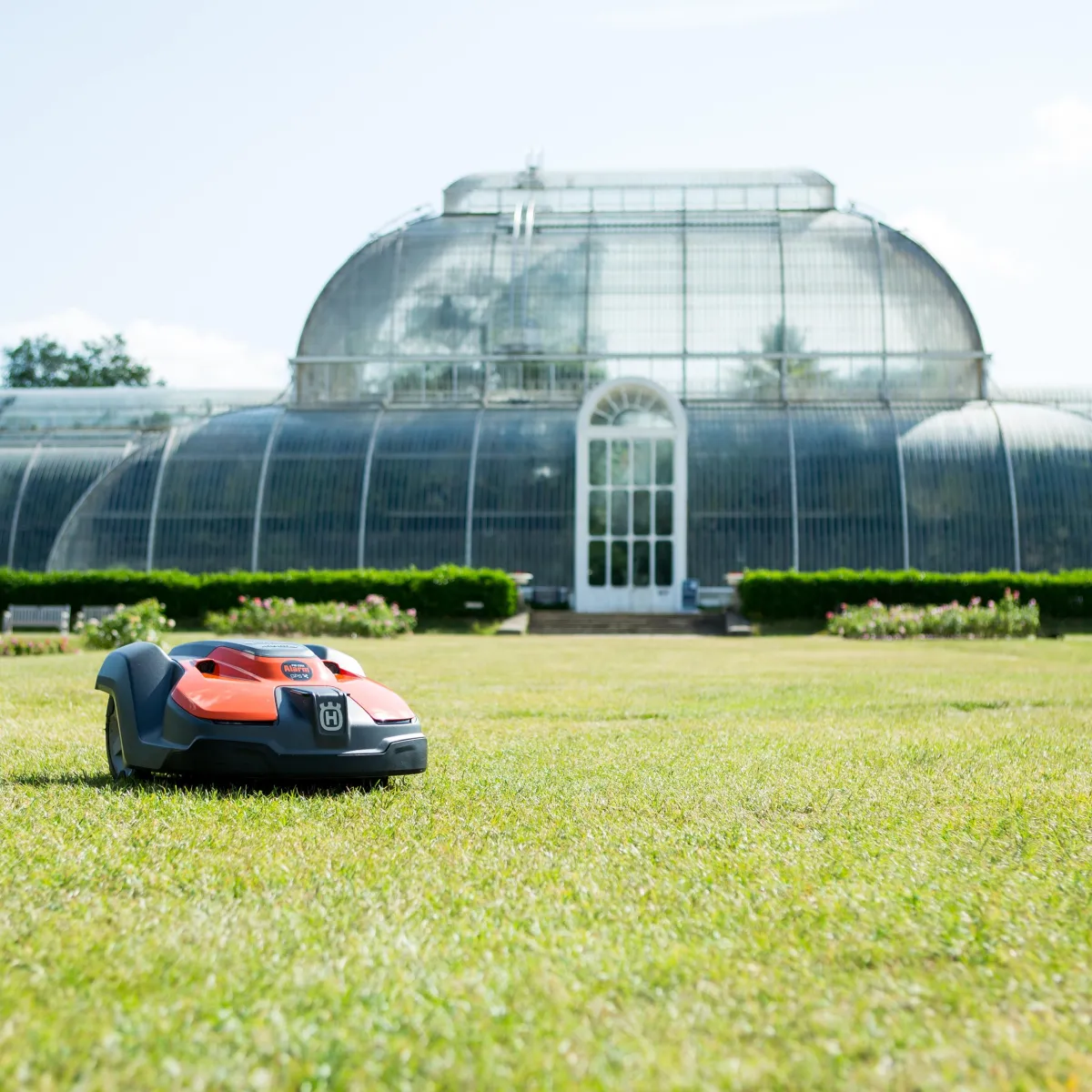 orange robotic lawn mower product photography at Kew Gardens London