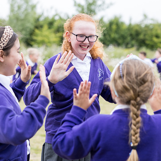 Group of children outside in the playground in  Bedfordshire school 