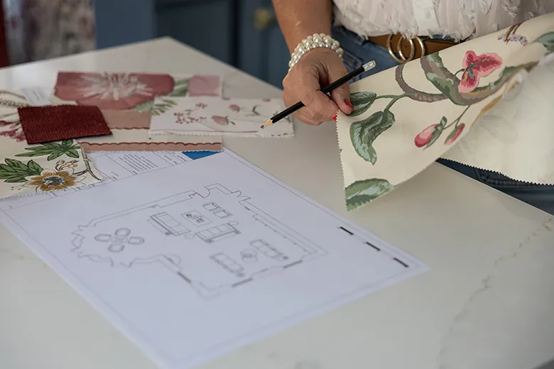 interior designer with fabric and design drawing photographed in her Bedfordshire studio 