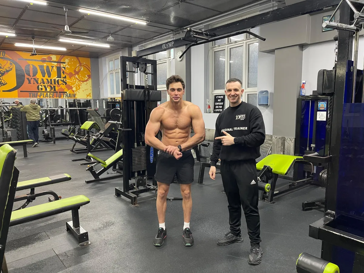 Personal trainer helping client strengthen core muscles during strength training