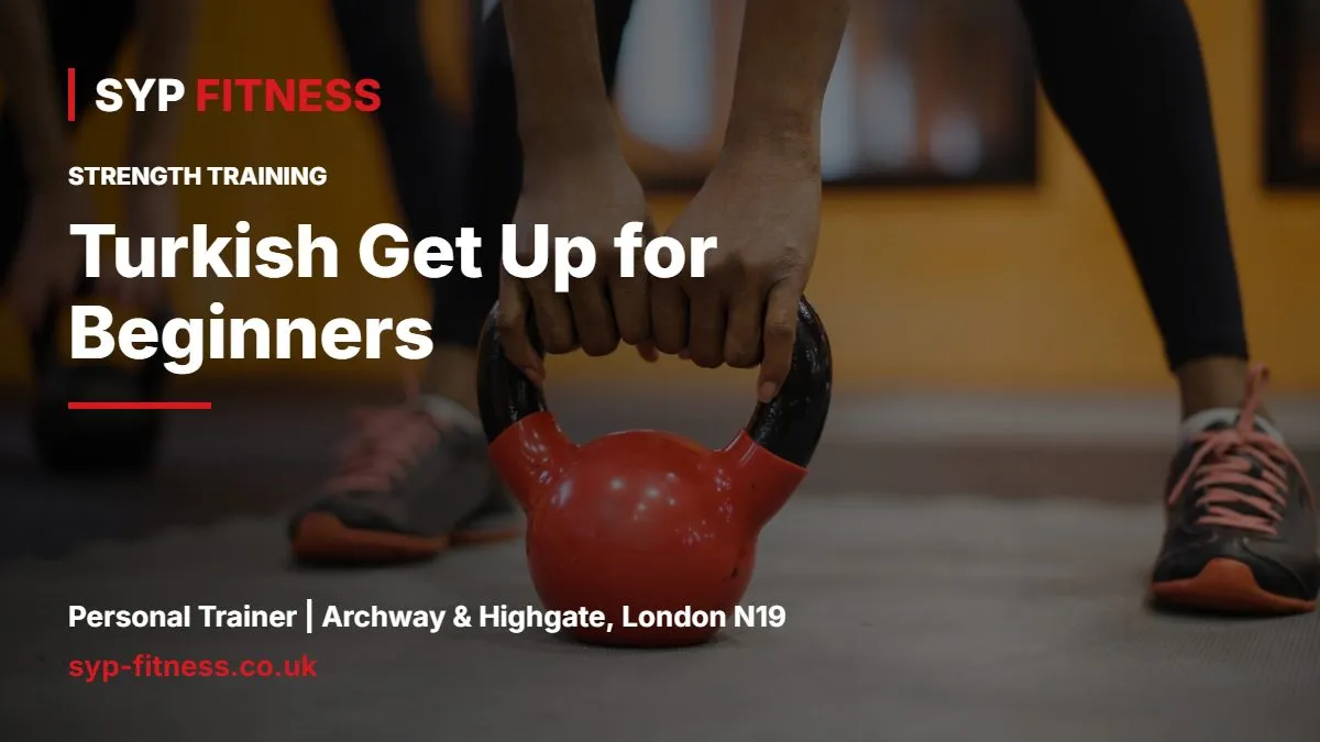 Hands gripping a red kettlebell in a gym - Turkish Get Up for Beginners: Step-by-Step Guide, SYP Fitness personal trainer Archway N19