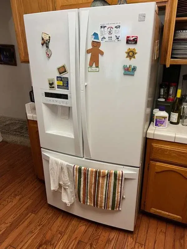 French door refrigerator repair service being completed by a local technician in Fresno, CA near the Woodward Park area.