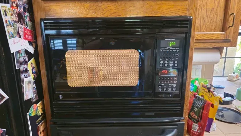 Built-in microwave repair service being performed in Fresno, CA near the Woodward Park area