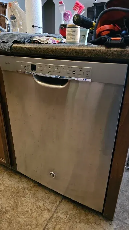 Dishwasher repair service being performed in Fresno, CA near the Woodward Park area.