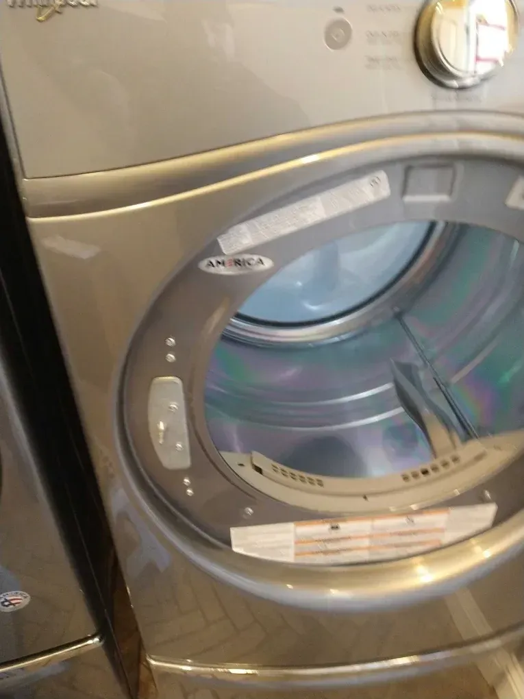 Professional appliance specialist checking internal water valves on a washing machine in Fresno, CA near the River Park district.