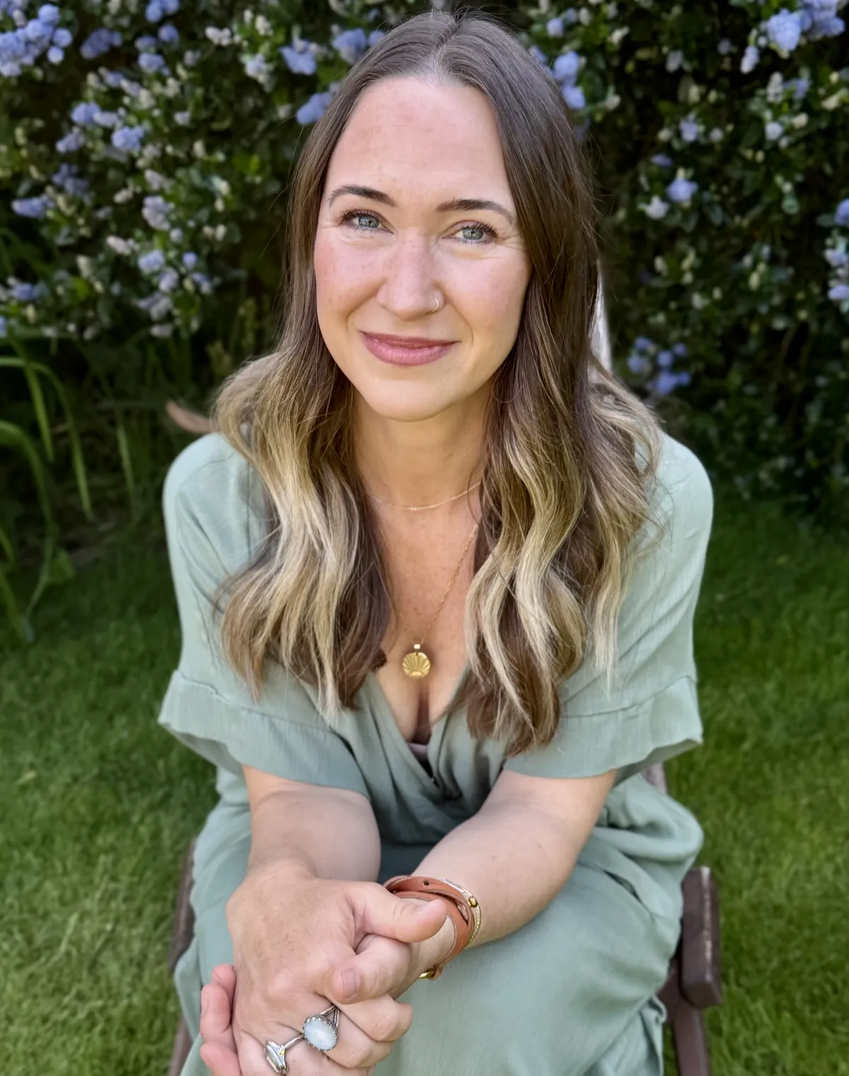 Britni sitting on a chair smiling