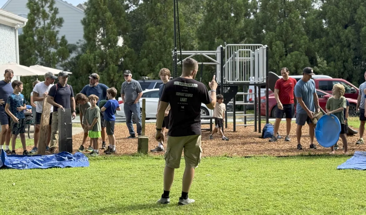 Mentor teaching boys and dads
