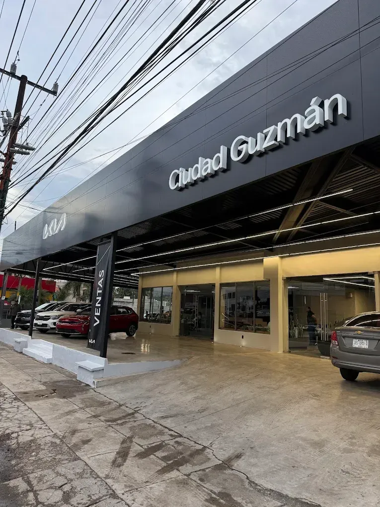 A white BMW and other cars are on a street.
