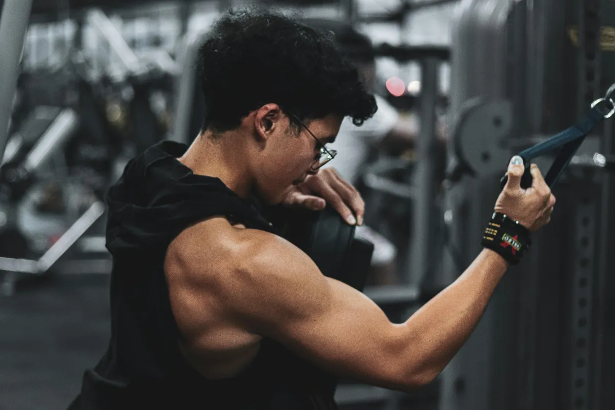 topless man in black shorts doing exercise