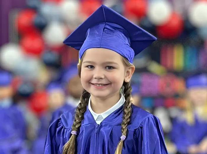 Pre-kindergarten graduate in cap and gown, ready for the next stage of their educational journey at Curious Minds Early Years Academy, Horizon West