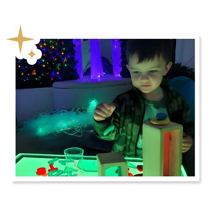 Young child discovering light and textures through play at Curious Minds childcare academy